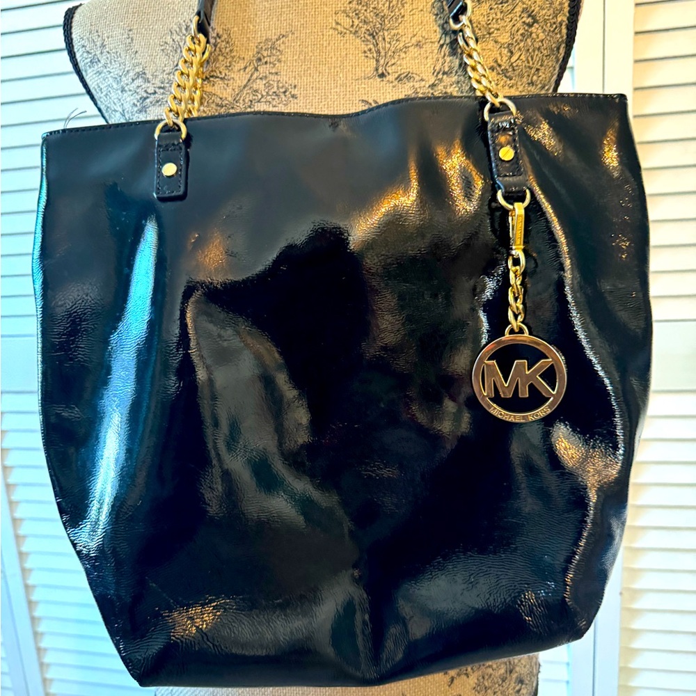 Michael Kors black patent leather purse with gold tone MK dangle charm